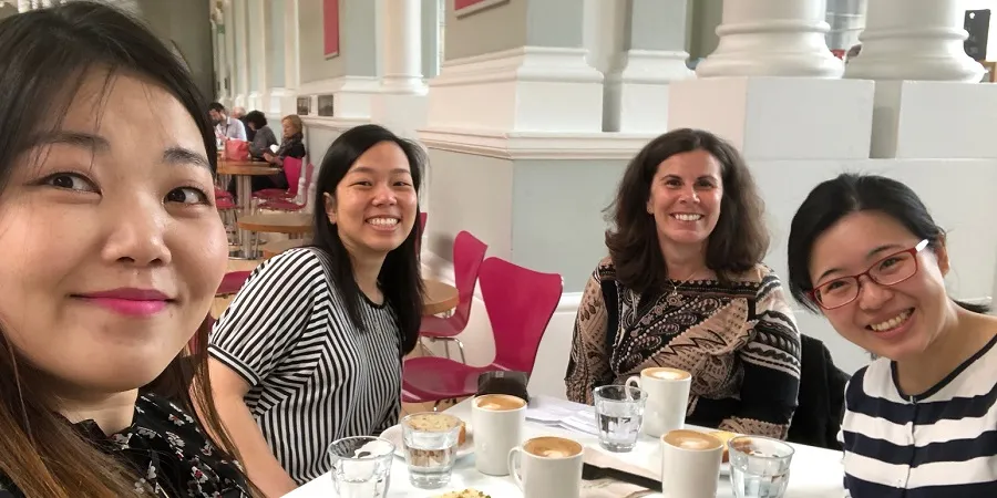 Students and staff having coffee and cake