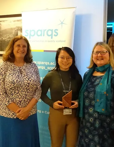 Project team accepting award trophy